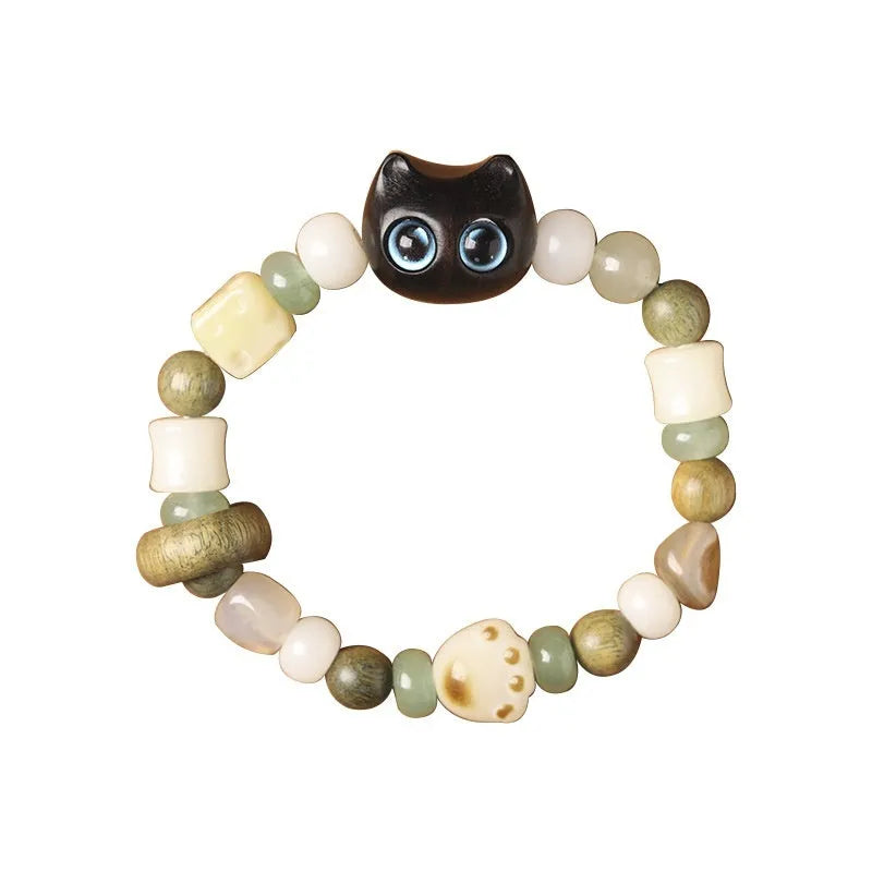 Hand-woven beaded bracelet with bodhi, jade, and ebony beads featuring a cartoon cat's paw charm.