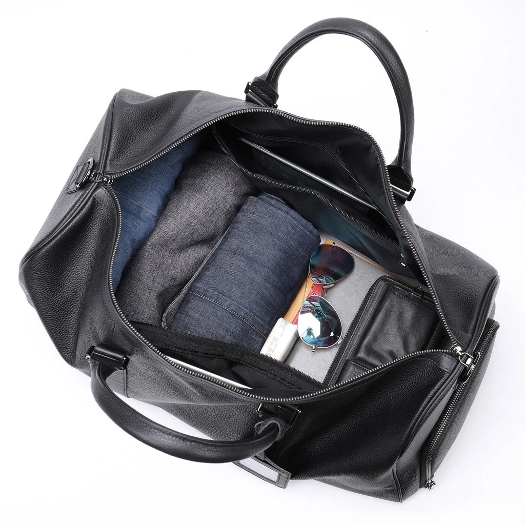 Men's black leather excursion bag with single shoulder strap showing large capacity design