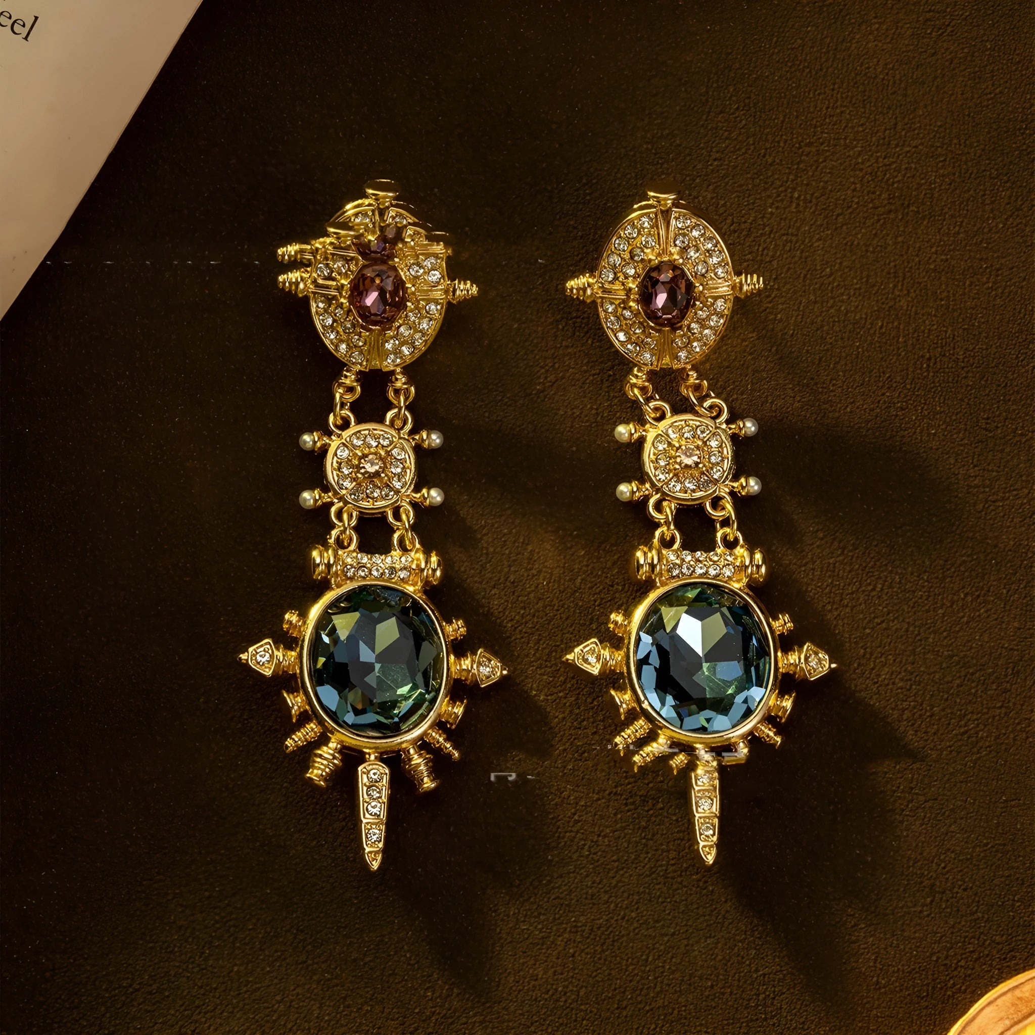 A pair of round geometric stud earrings with a gold finish and retro court style design.