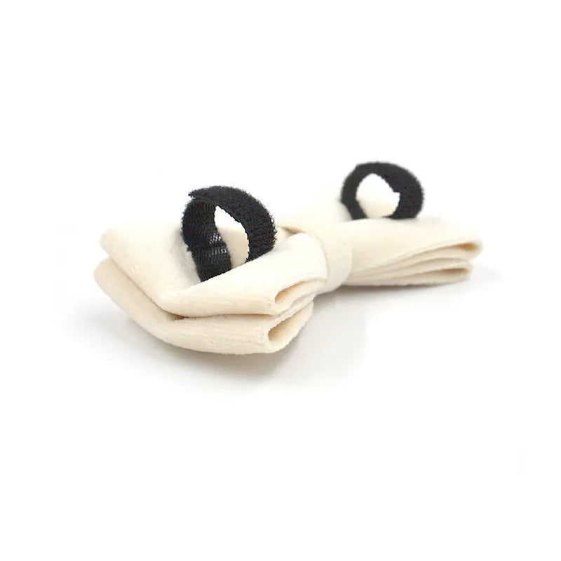 Cream velvet dog collar with gold buckle, matching bow tie, and leash set on a white background
