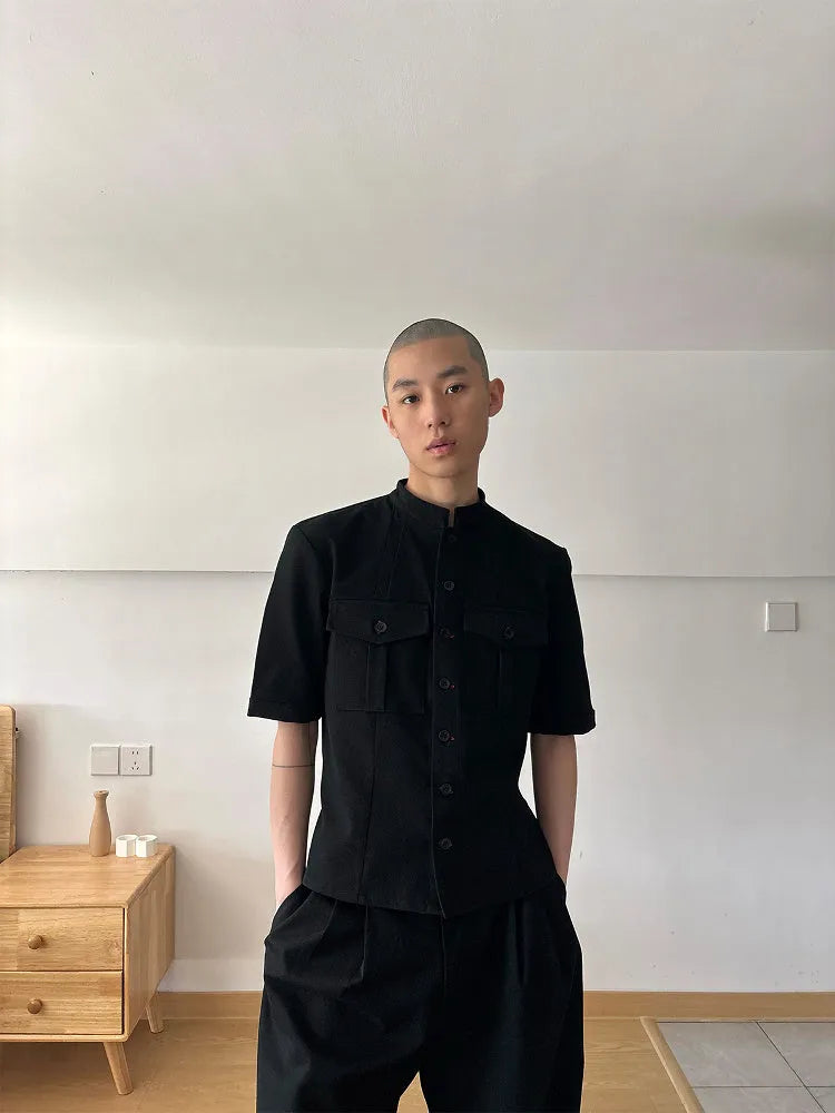 Handmade black half-sleeve hunting shirt with a shirt collar and single-breasted placket on a hanger.