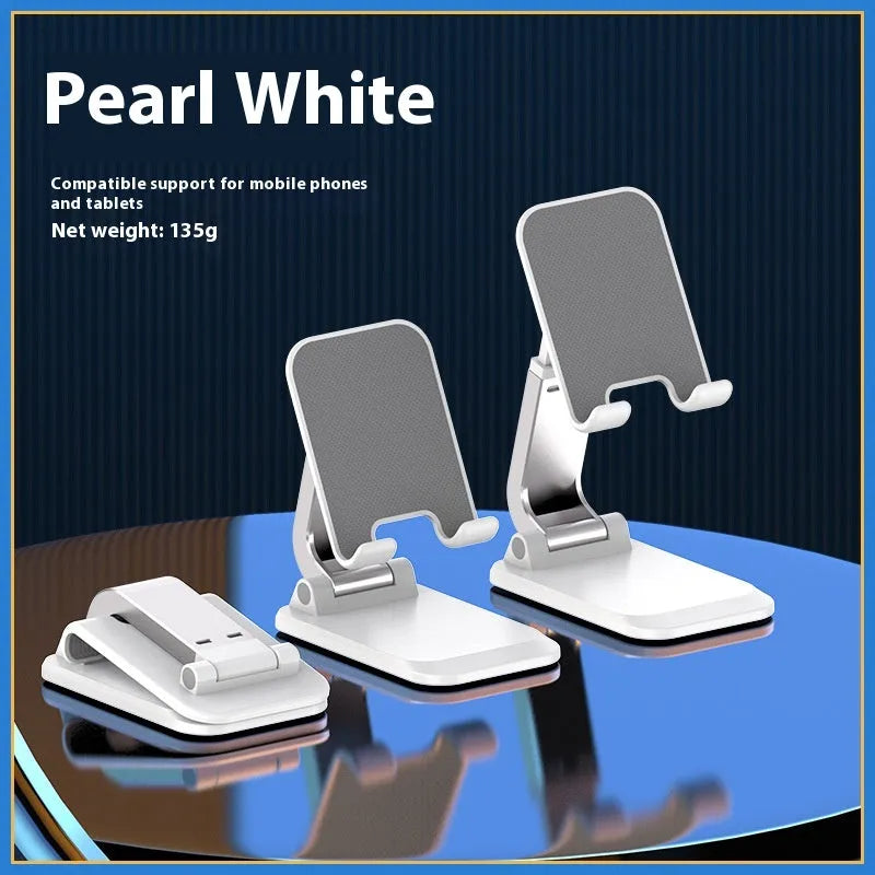 Foldable aluminium alloy phone holder in black on a wooden desk with a smartphone propped up for viewing