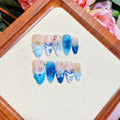 Blue false nails with hand-painted carved summer ice transparent design, shown in XS, S, M, L sizes.