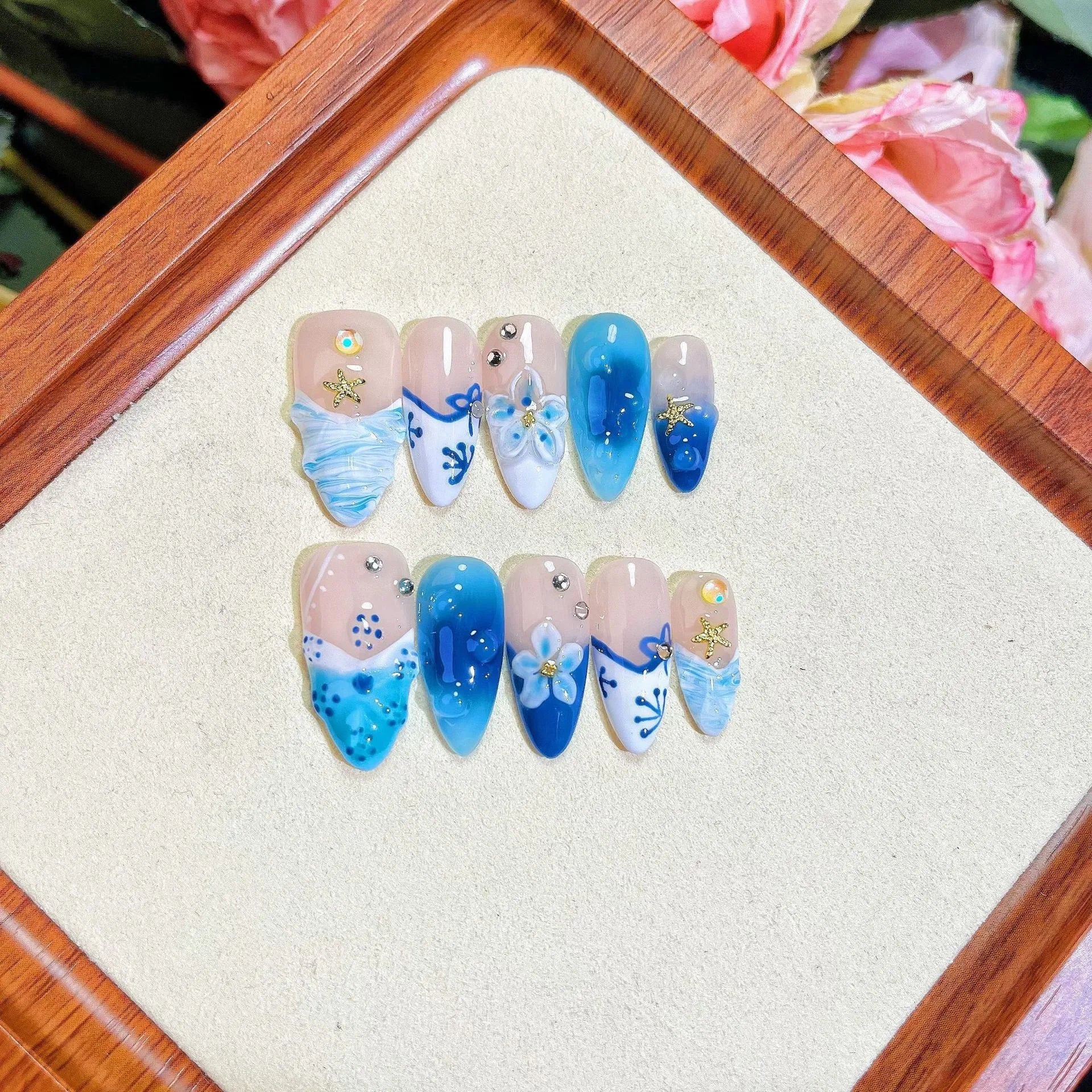 Blue false nails with hand-painted carved summer ice transparent design, shown in XS, S, M, L sizes.