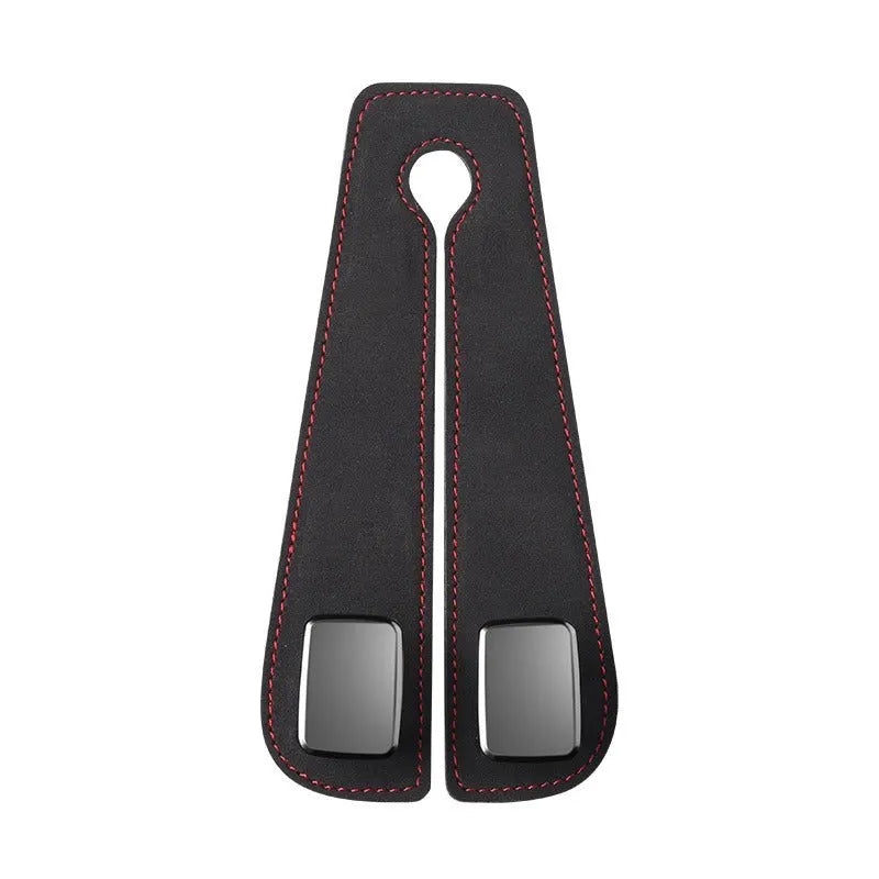 Black car seat hook with suede padding and flip-back design mounted on a grey car seat