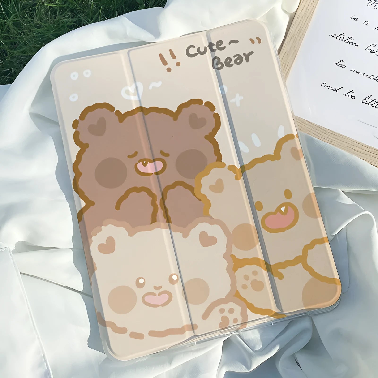 Flat tri-fold silicone iPad case with rabbit cartoon design on a table.