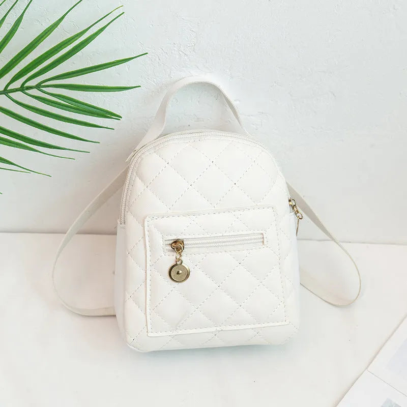 Girls' hard structured backpack with embroidery in white, black, or pink colours, showing front view and soft handle.
