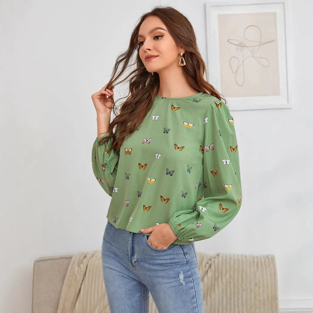Women's green long-sleeved loose shirt with butterfly print pattern.