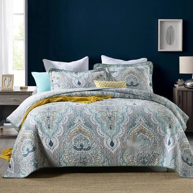 Quilted pure cotton bed cover with printed design, shown on a double bed with two matching pillowcases.