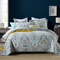 Quilted pure cotton bed cover with printed design, shown on a double bed with two matching pillowcases.