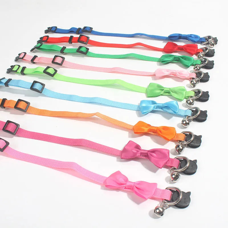 Colourful striped nylon bow collar for cats with an adjustable strap and small bell attached.