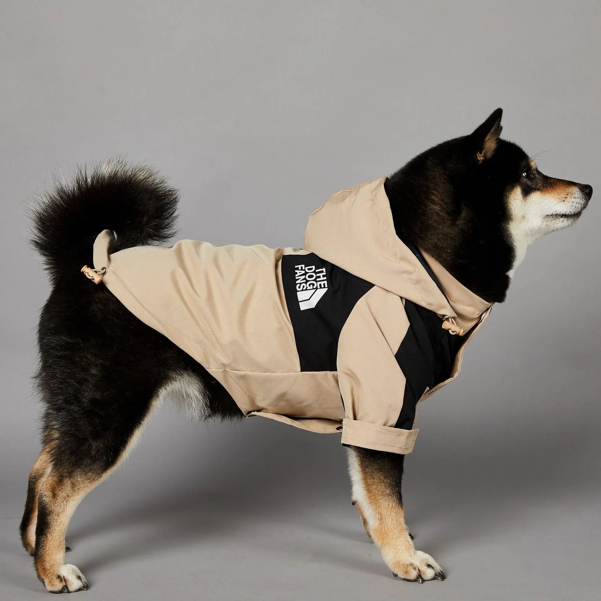 Khaki coloured polyester shell jacket for a dog, shown on a mannequin.
