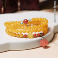 Yellow amber bracelet with 5mm round beads and animal zodiac design on wrist
