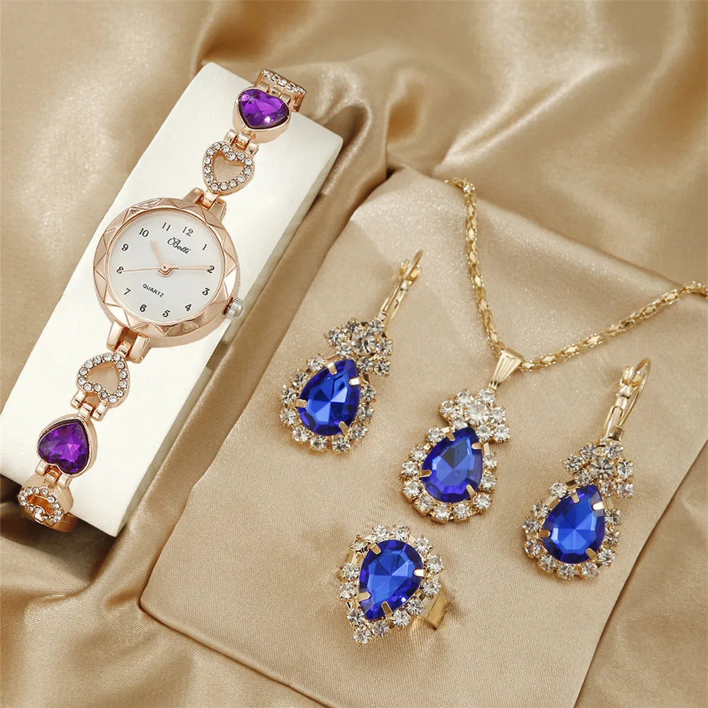 Women's quartz bracelet watch set with earrings necklace ring in pink finish on display