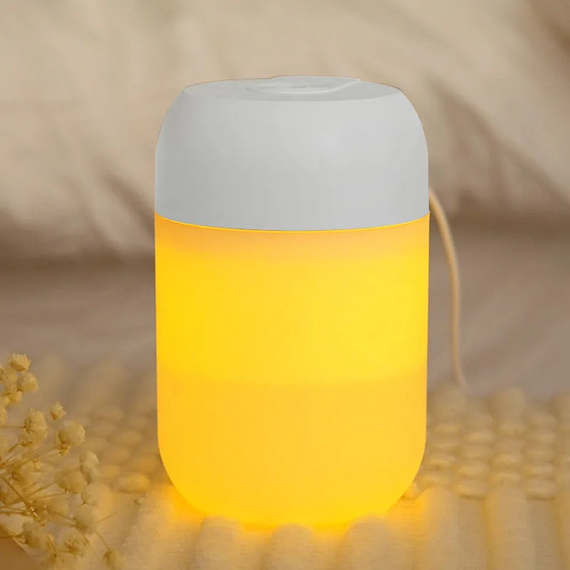 Small white cylindrical USB-powered personal humidifier on a desk.