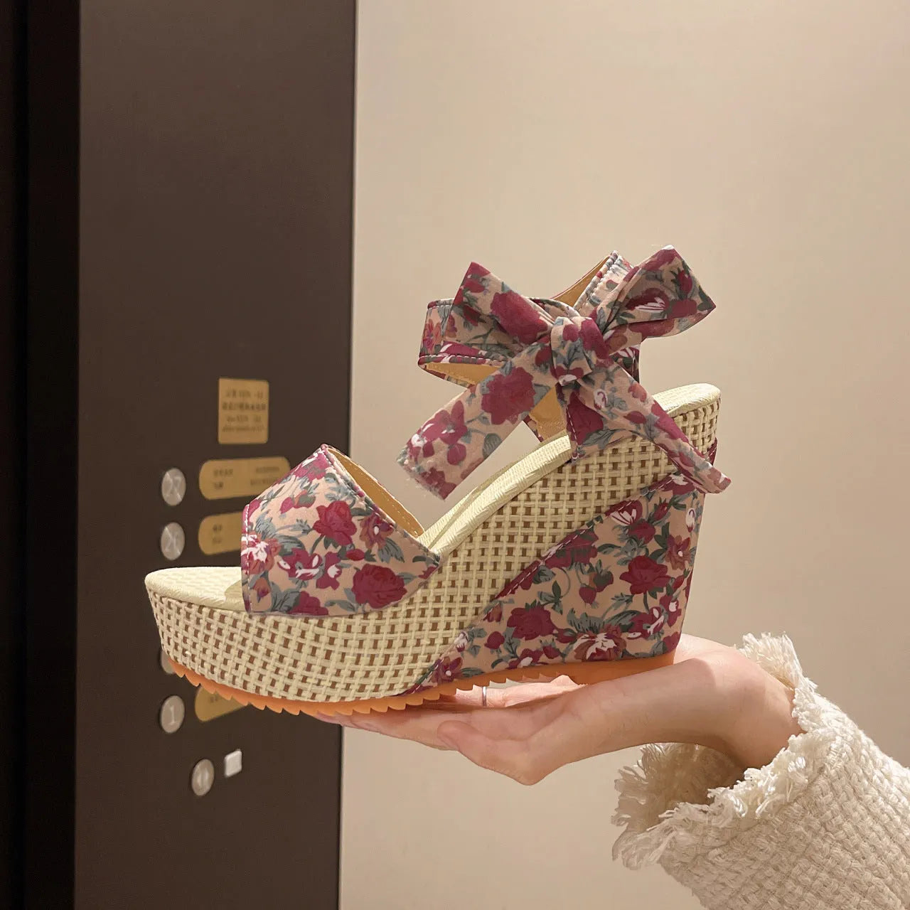 Women's floral wedge sandals with fish mouth peep toe and ankle strap buckle in pink, black, and blue patterns.