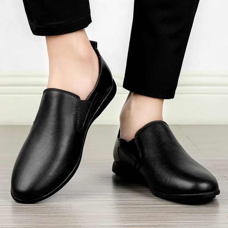 Men's black and brown cowhide leather shoes with round toes on a white background.