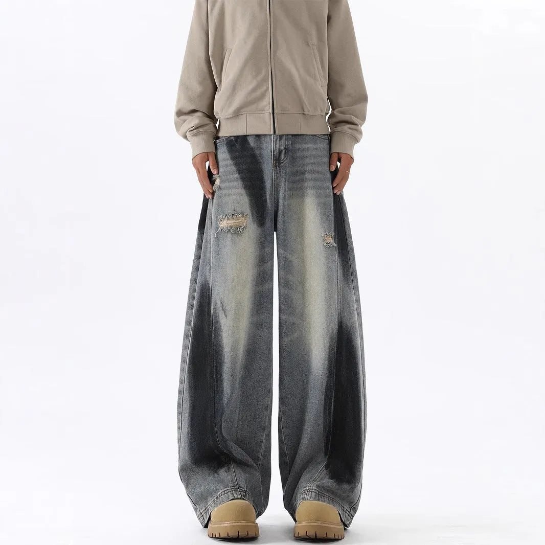 Men's blue distressed jeans with splash-ink patterns and rips in loose fit American style