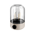 Beige and black rechargeable camping ambience light with control knob, shown with size scale.