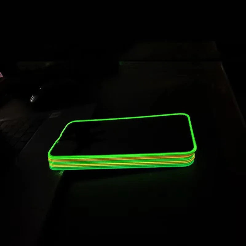 Fluorescent pink tempered glass screen protector fitted on an iPhone 13, showing full-screen coverage and luminous glow.