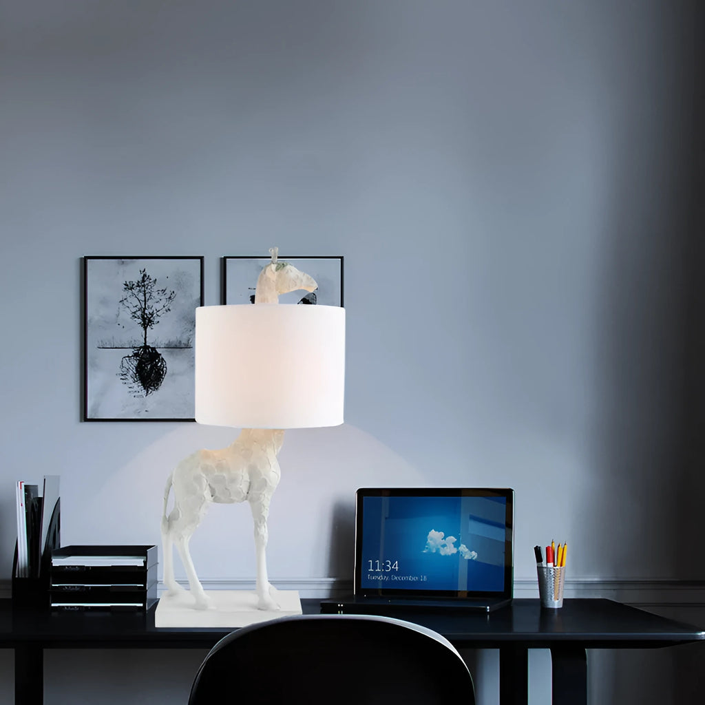 Giraffe table lamp with resin base and cloth shade, 66cm high, in white finish on a bedside table
