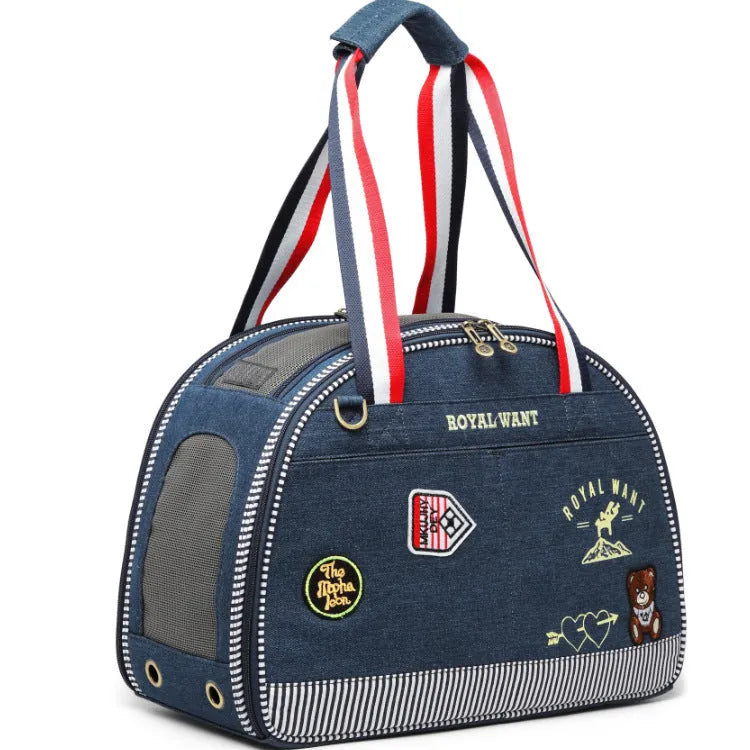 Blue cartoon-patterned denim pet nappy bag with shoulder strap.