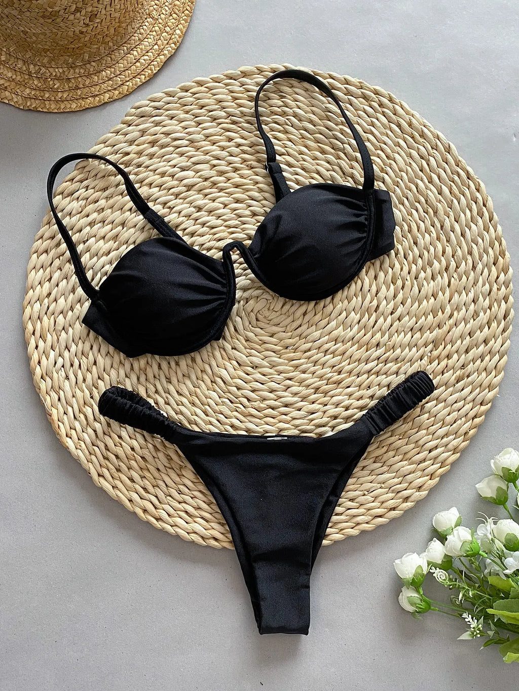 Women's black underwire bikini swimsuit with split high-leg briefs on mannequin