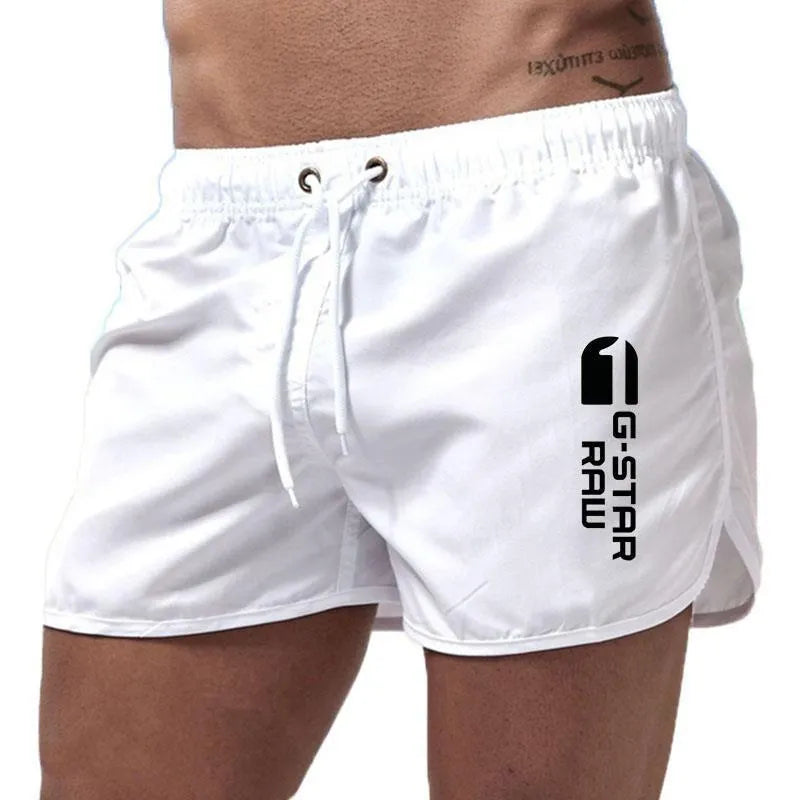 Men's thin polyester sports shorts in various colours with an elasticated waistband.