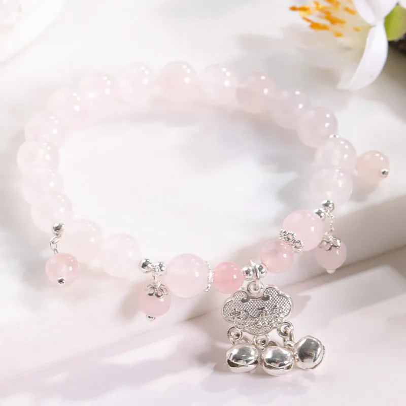 Close-up of a women's opal cat's eye stone beaded bracelet with diamond-shaped beads on a wrist.