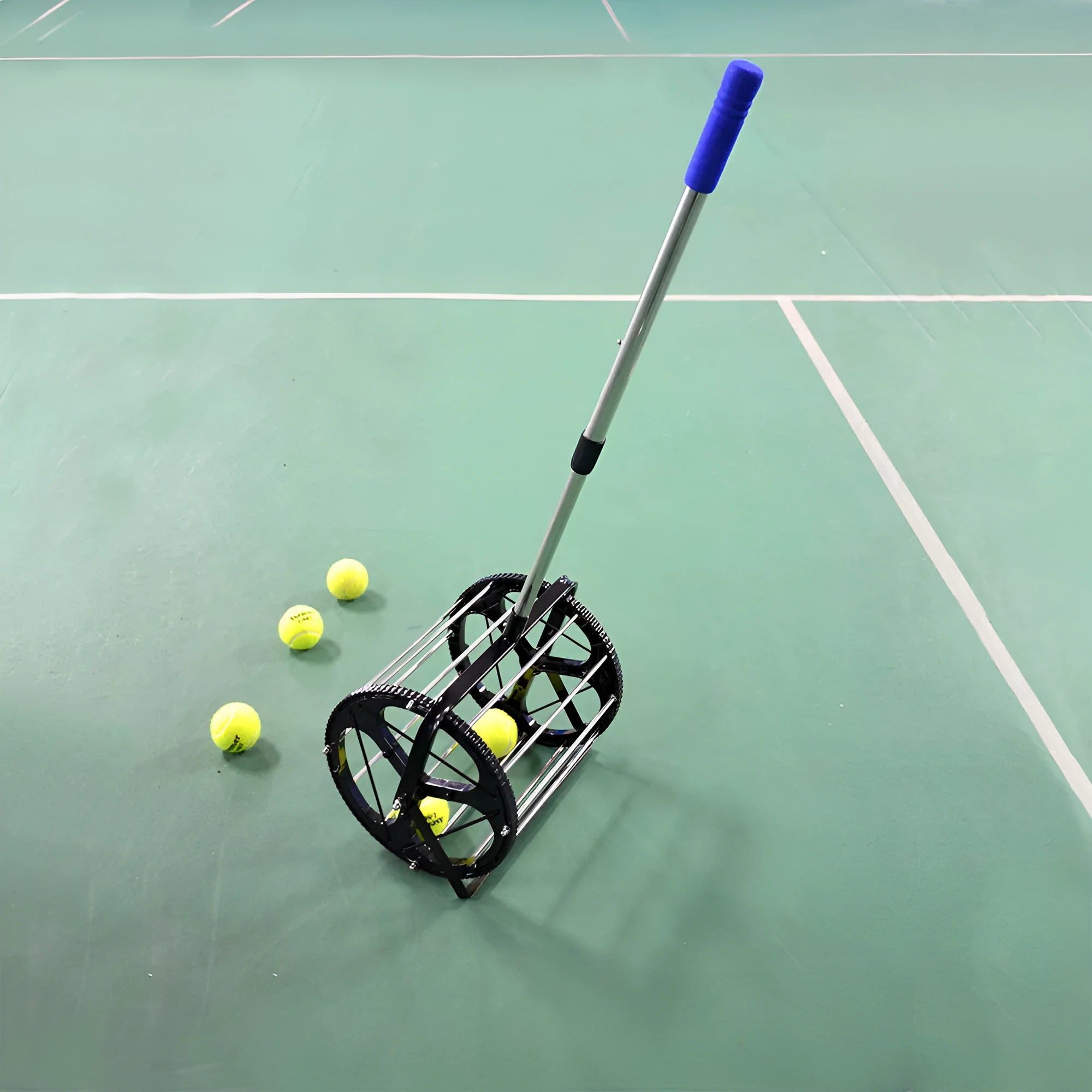 Black tennis ball picker basket made from nylon and metal, holding multiple tennis balls on a court