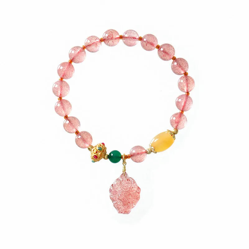 Women's Nine Tail Fox style strawberry quartz crystal beaded bracelet on wrist
