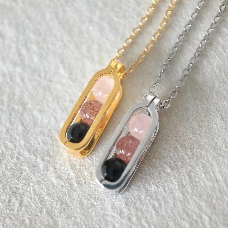 Minority simple pearl necklace with gold titanium steel chain and inlaid pearl pendant on plain background