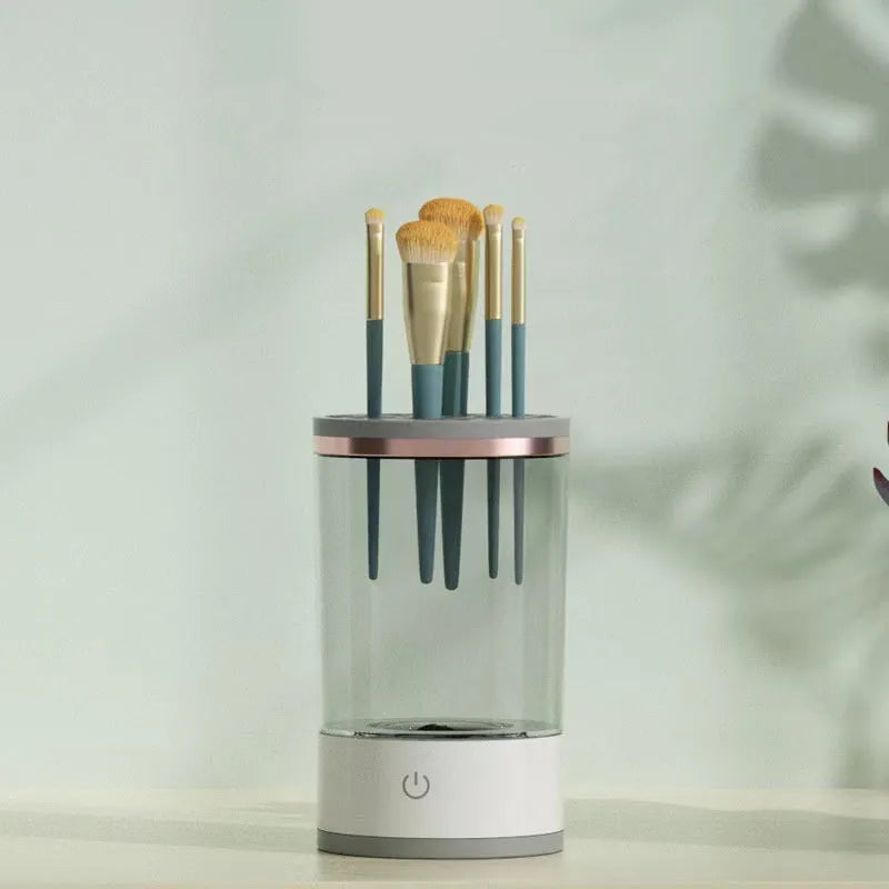 Electric makeup brush cleaner in grey and white with brush inserted, 17x9x9 cm, USB charging