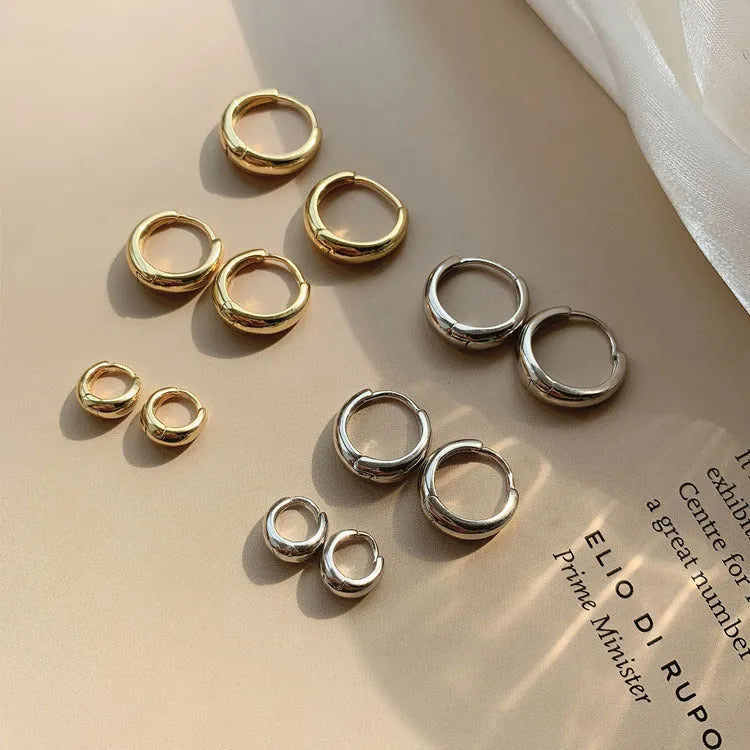 Women's geometric water drop earrings in gold or silver, shown in large, medium, and small sizes.
