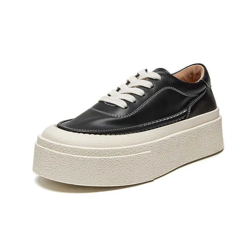 Women's black and white platform sports board shoes with embossed cowhide uppers and round toe design