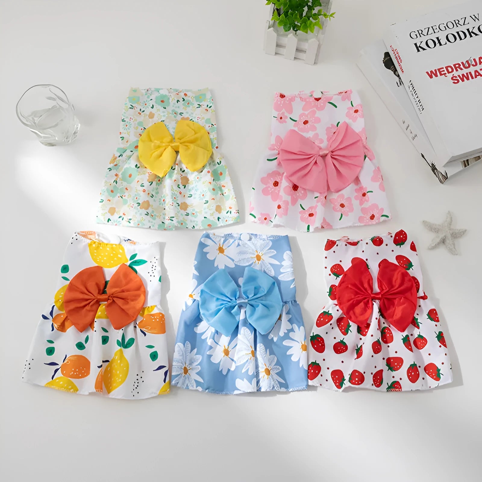 Ultra-thin floral butterfly knot princess dress for a dog or cat in summer, shown with a blue bow.