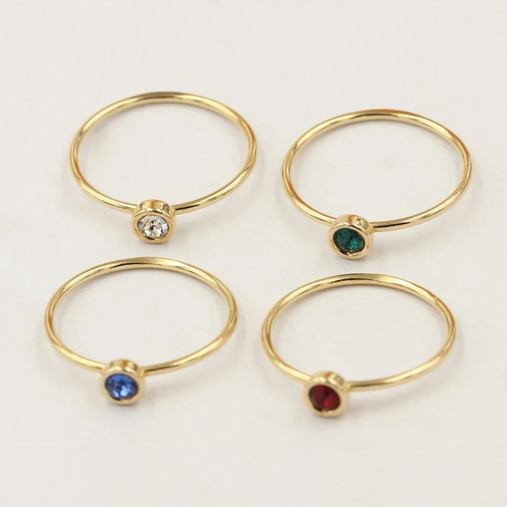 Women's copper knuckle ring with 14K gilding and zircon stones in green, blue, dark red, or white.