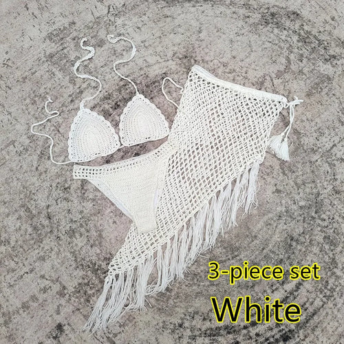 Women's white handmade crochet bikini swimsuit set with a separate matching skirt.