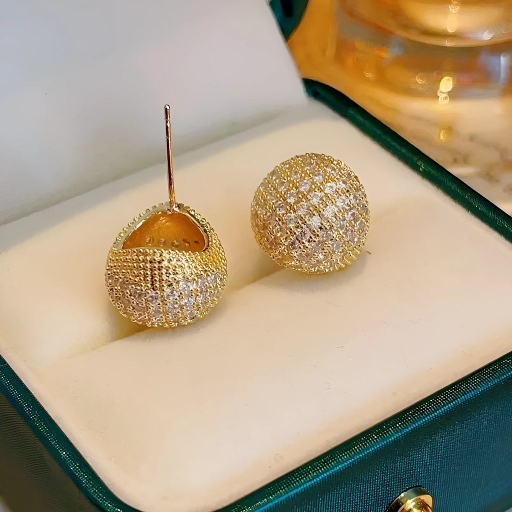 Geometric drop-shaped earrings with full diamond detailing, spherical elements, and little golden beans motif in gold or white colour