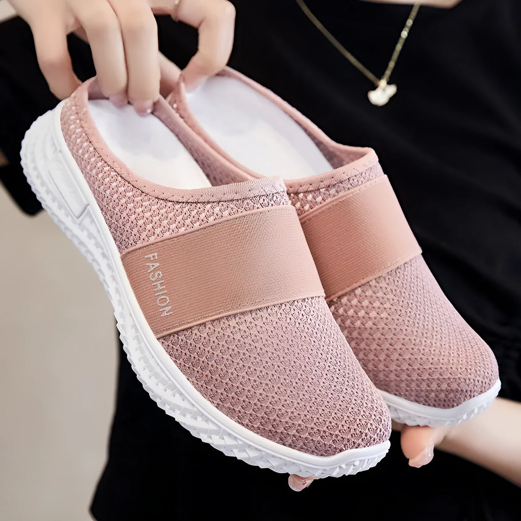 Women's breathable mesh casual shoes in black with a round toe, flat heel, and hollow out design detail.