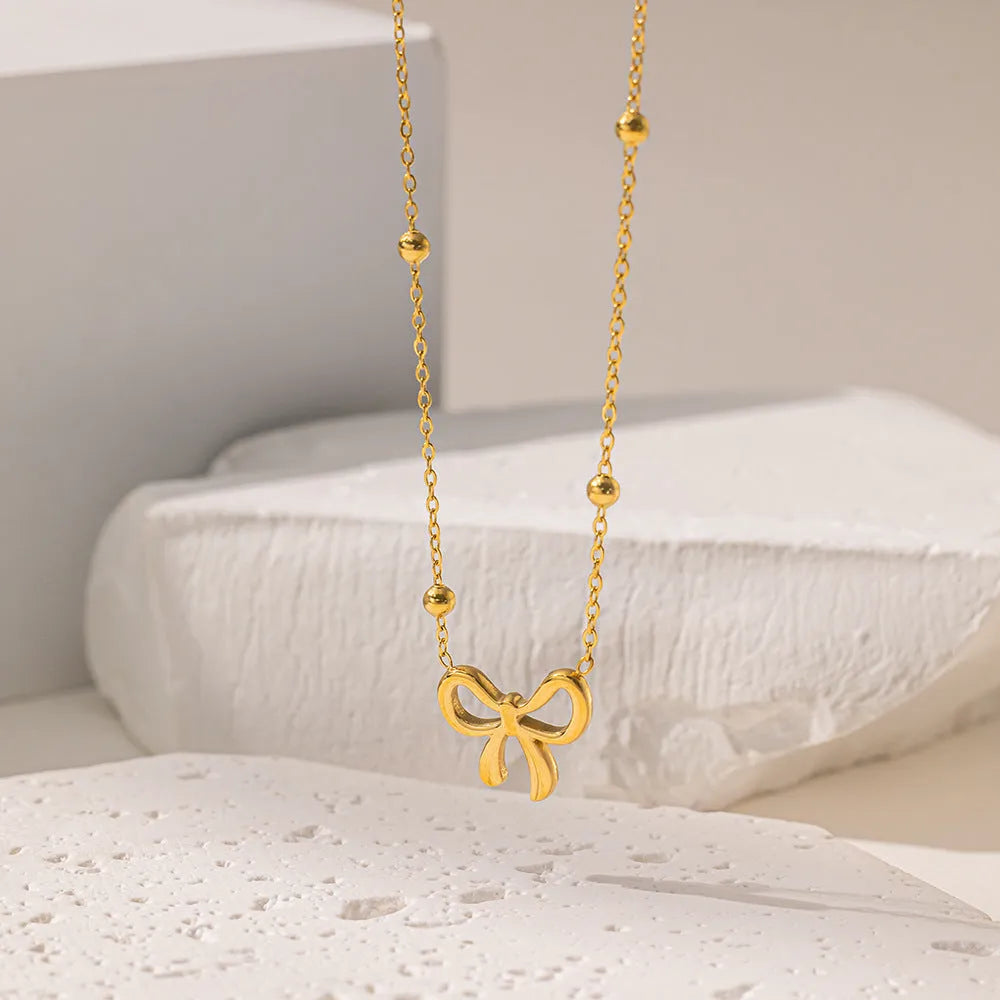 Gold electroplated bow necklace on titanium steel chain with adjustable 41-50cm length