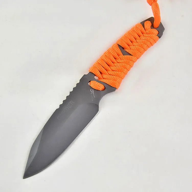 Straight camping survival knife with binding rope handle next to ABS sheath