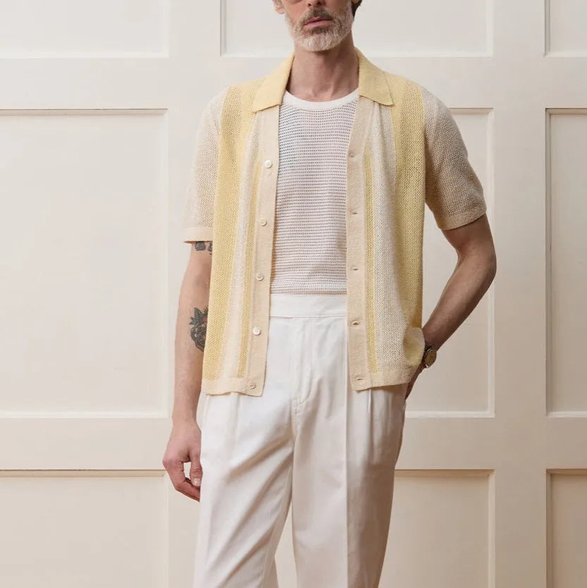 Yellow casual polo shirt with hollow-out design and asymmetric cut, short sleeves, made from Tencel fabric.