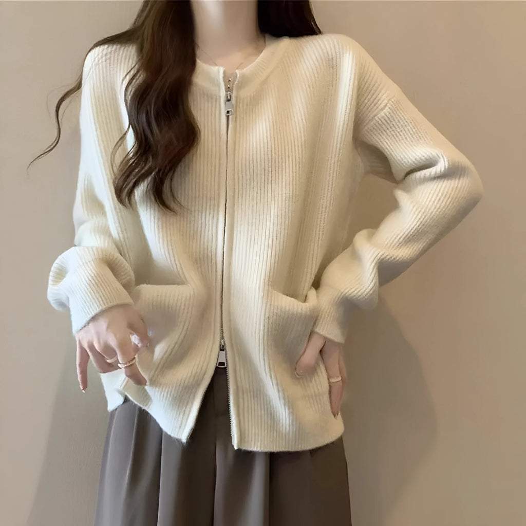 Beige temperature-sensitive viscose sweater coat, long sleeve cardigan style on a hanger.