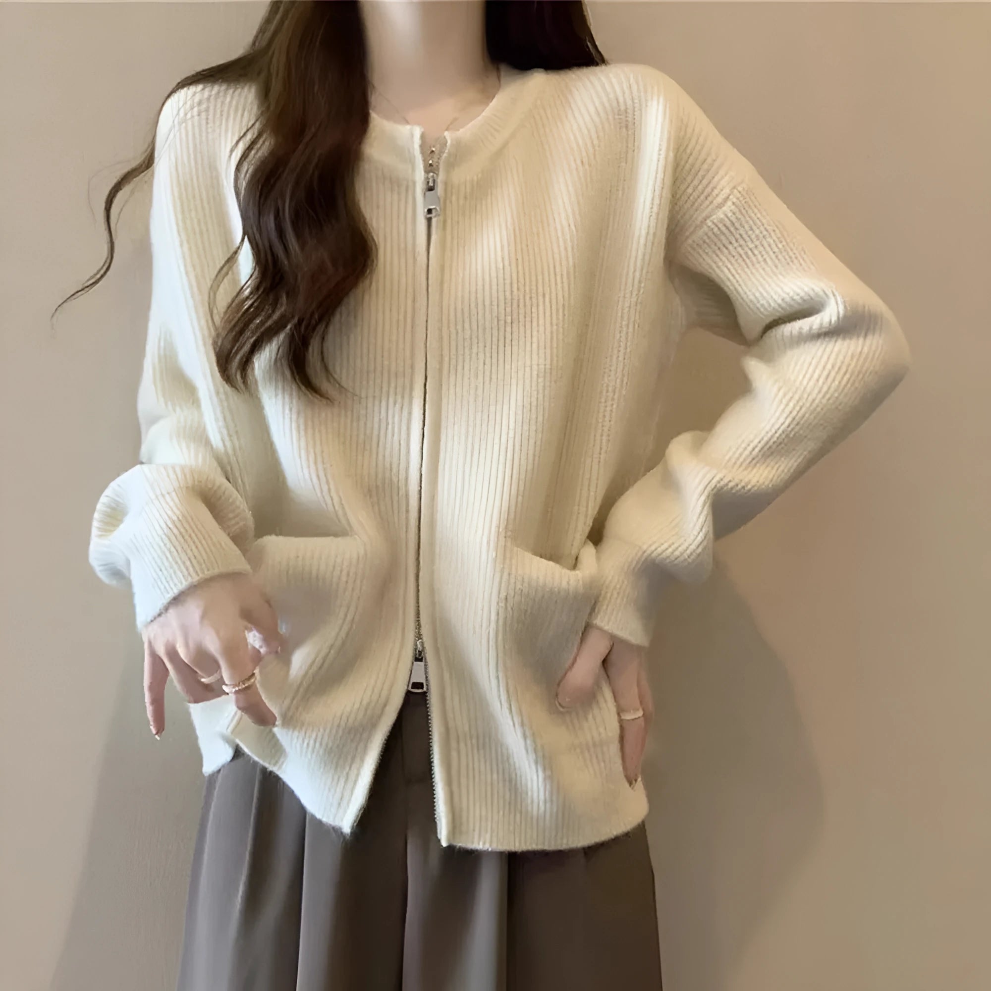Beige temperature-sensitive viscose sweater coat, long sleeve cardigan style on a hanger.