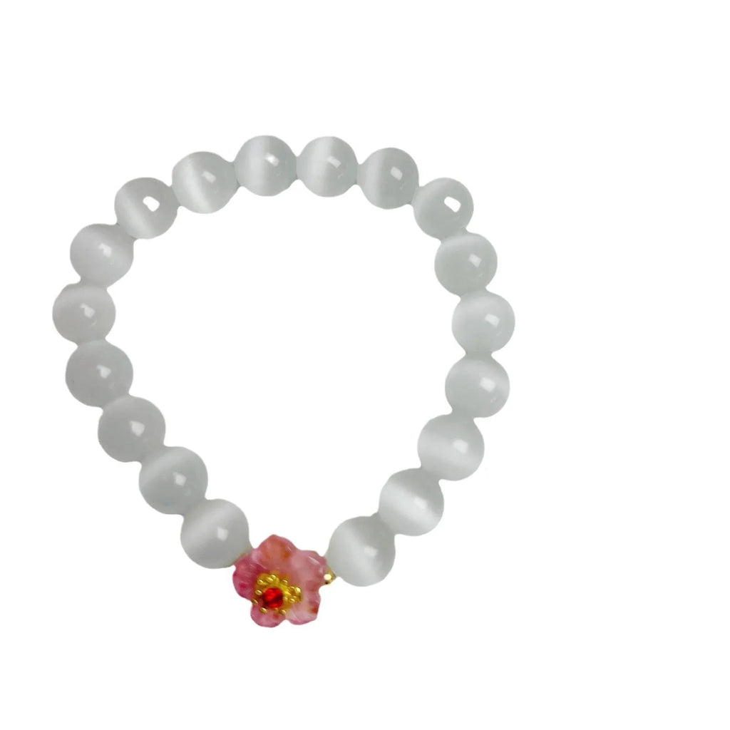 Handmade glass bead bracelet with floral design in green, pink, white, or yellow.