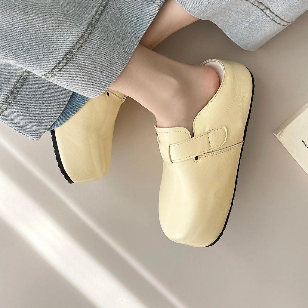 Flat buckle casual slippers with round toe and PU upper in beige colour on a clean surface