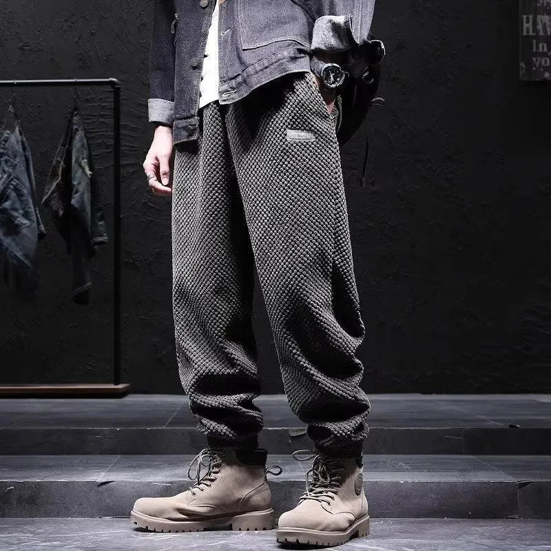 Men's grey casual sweatpants with elastic ankle ties in straight cut style for sport and leisure