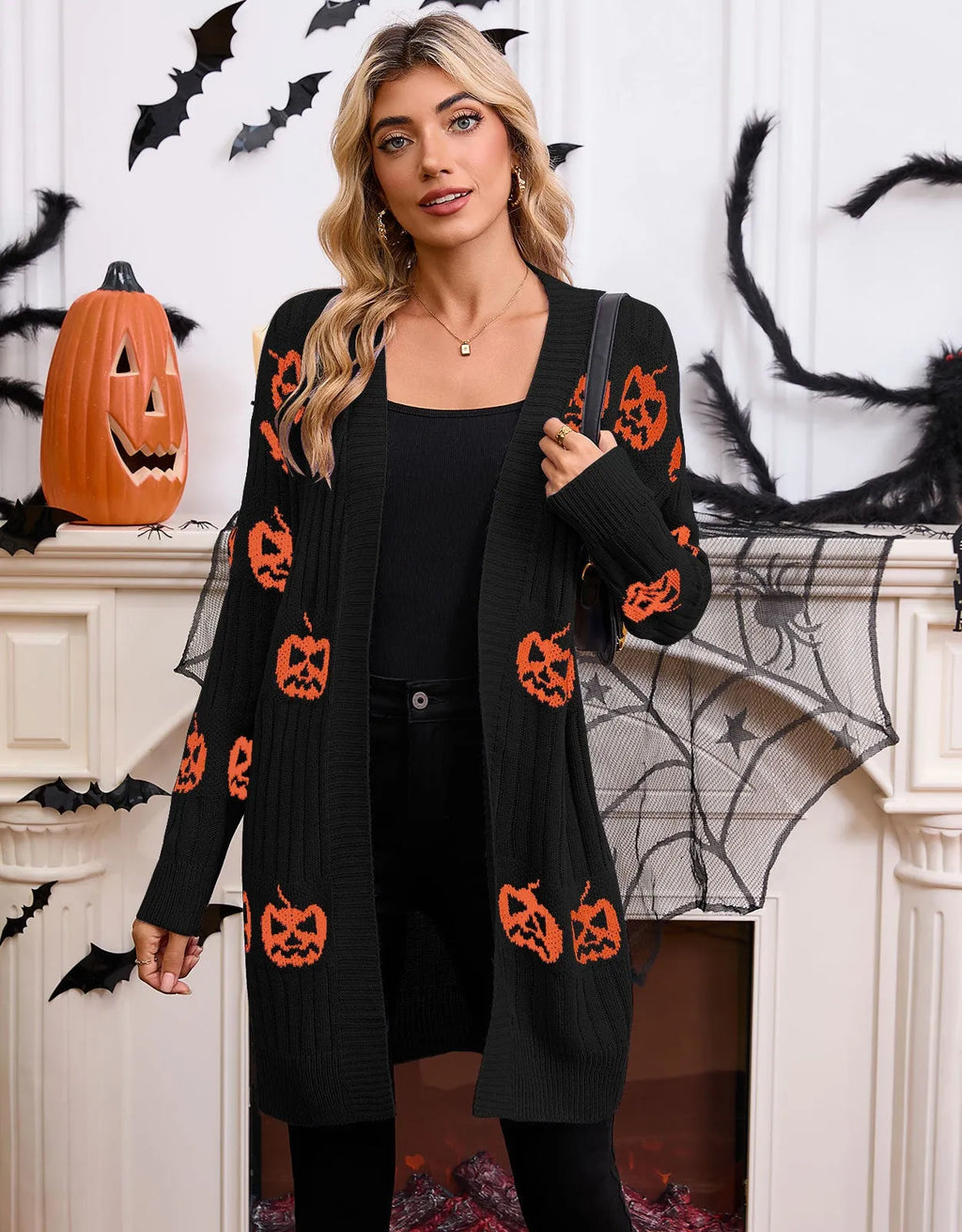 Women's black cardigan with orange knitted pumpkin head jacquard pattern.
