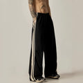 Black men's wide-leg high-waist climbing trousers laid flat, showing straight-leg cut.